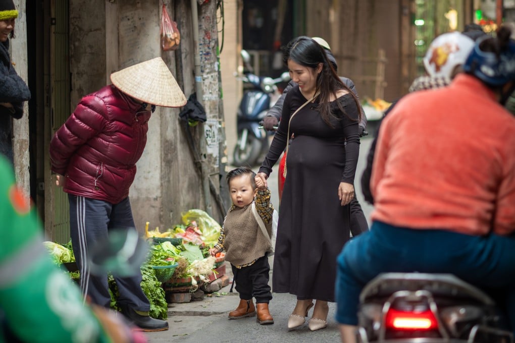 A pregnant woman walks with her young son in Hanoi. Vietnamese culture is still influenced by Confucianism and couples still tend to hope for sons. Photo: Shutterstock