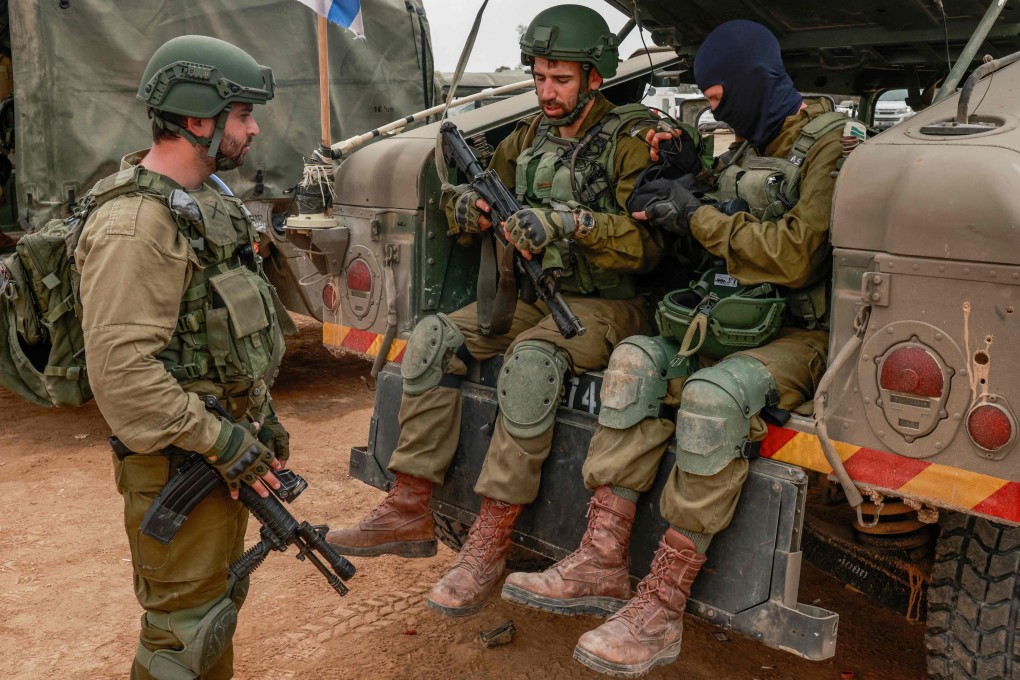 Israeli soldiers gather near the border with the Gaza Strip on Tuesday amid continuing battles between Israel and the militant group Hamas. Photo: AFP