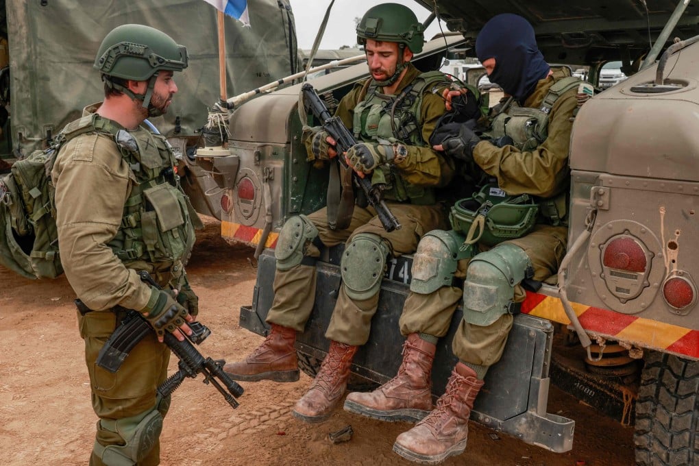 Israeli soldiers gather near the border with the Gaza Strip on Tuesday amid continuing battles between Israel and the militant group Hamas. Photo: AFP
