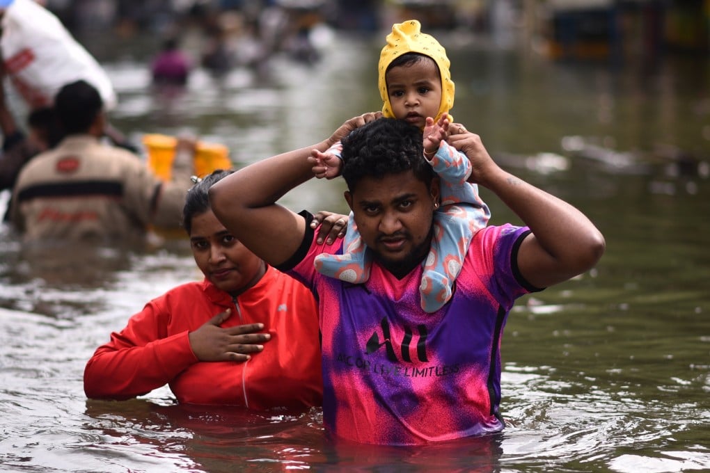 People wade through a flooded street following heavy downpour during ‘Cyclone Michaung’, in Chennai, India. Photo: EPA-EFE