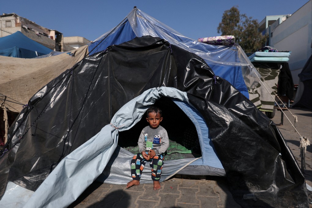 A child sits in a tent as Palestinians shelter at a United Nations-run school in Khan Younis, in the southern Gaza Strip. Photo: Reuters
