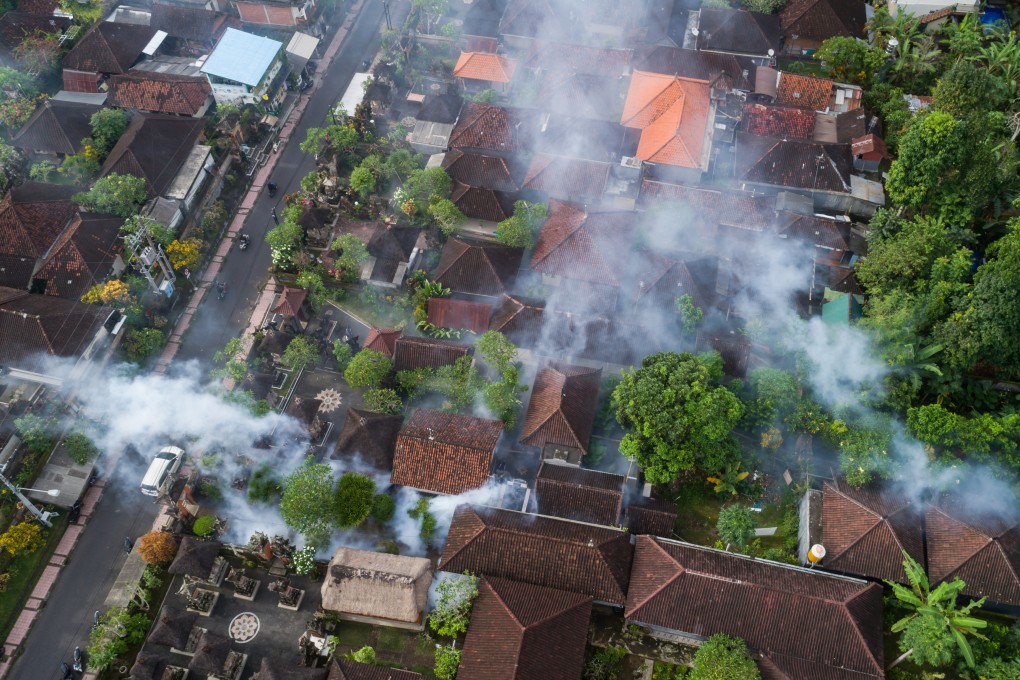 Indonesian workers fog a residential area in Ubud, Bali, with insecticides to kill the Aedes mosquito. Photo: Shutterstock