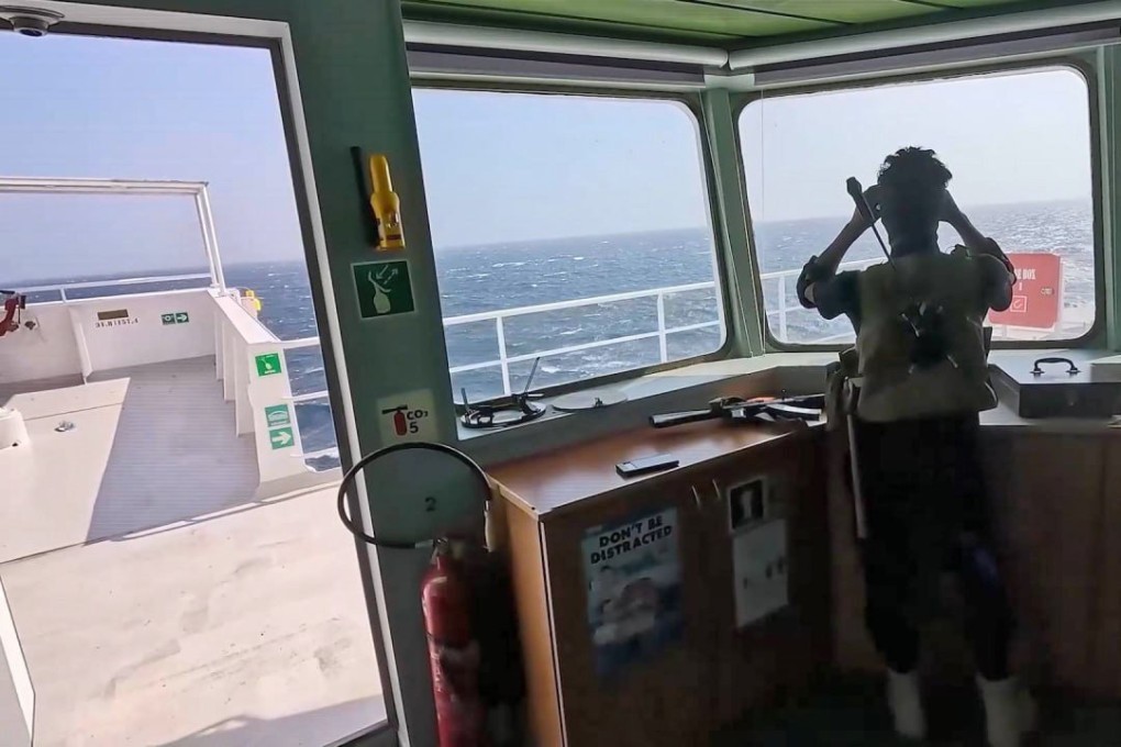 A Houthi fighter keeps watch onboard of the seized ship Galaxy Leader three days after the Houthis seized it in the Red Sea. Photo: EPA-EFE