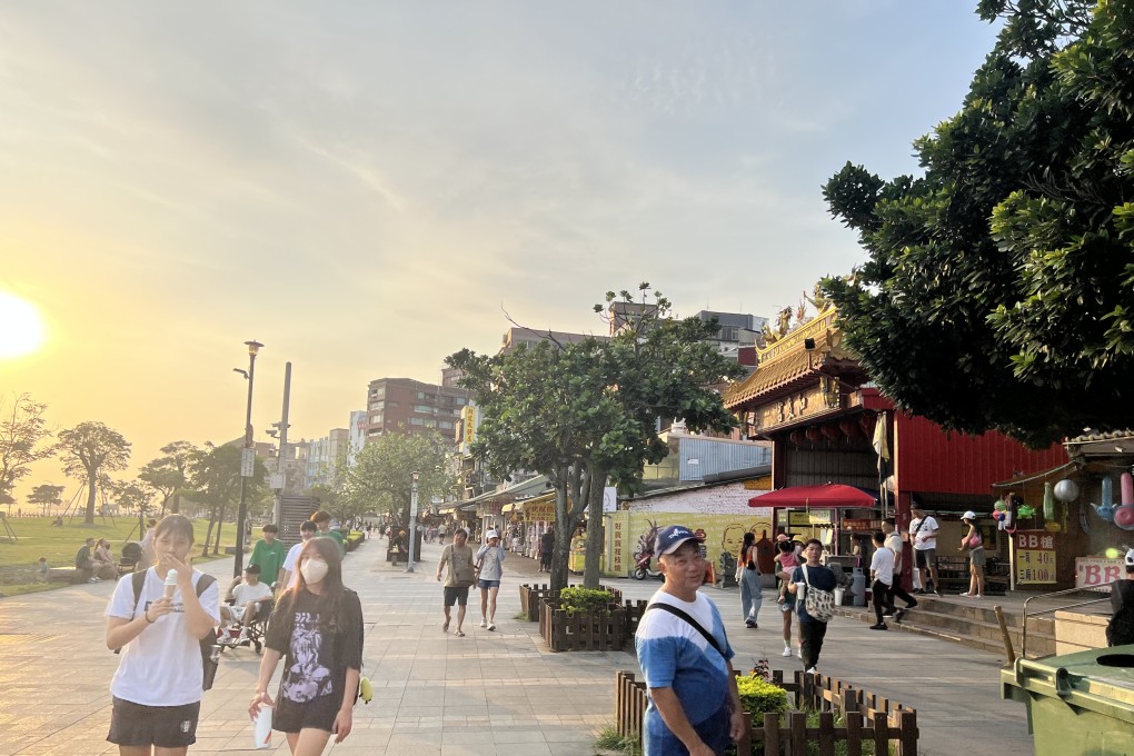 Shoppers and sunset gazers emerge in the tourist zone of Danshui, Taiwan, on August 7, 2023. Photo: Ralph Jennings