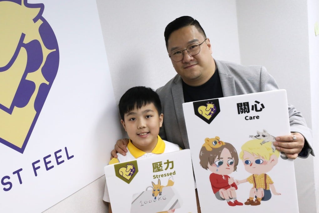 Hong Kong pupil Colin Choi (left) and his father Michael hold emotion cards provided by NGO Just Feel that help children show and discuss different emotions and how they’re expressed. Children in the city are still struggling with social skills after school went online during the pandemic. Photo: Sun Yeung