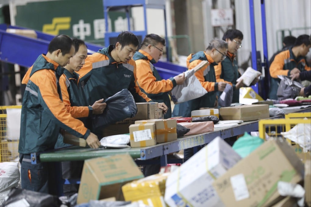 Staff members handle parcels at an express mail distribution center of China Post Group in Daoxian County, central China’s Hunan Province, on November 12, 2023. Photo: Xinhua