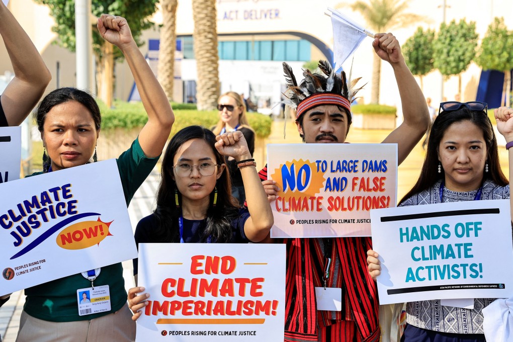 Activists hold placards and shout slogans during a protest at the UN Climate Change Conference in Dubai, United Arab Emirates, on December 6. Photo: Reuters