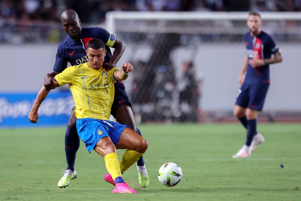 Paris Saint-Germain’s Danilo Pereira (back) fights for the ball with Al-Nassr’s Cristiano Ronaldo during a friendly at Nagai Stadium in Osaka on July 25. Photo: AFP