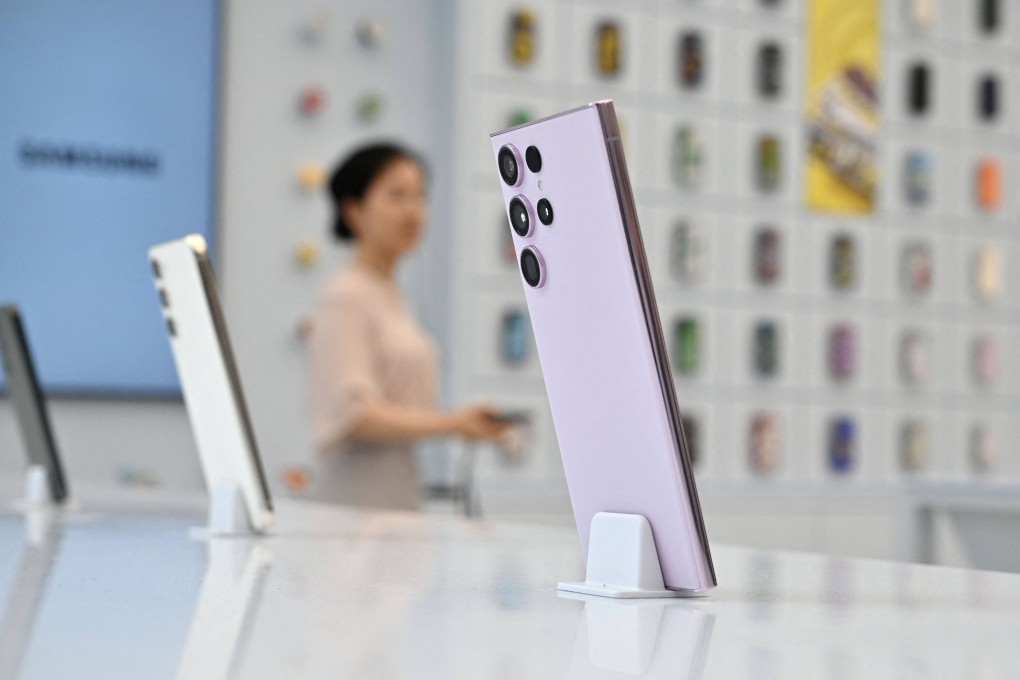 A woman walks past a Samsung Galaxy S23 Ultra smartphone on display during a media preview event for a new flagship store in the Gangnam district of Seoul on June 28, 2023. Photo: AFP