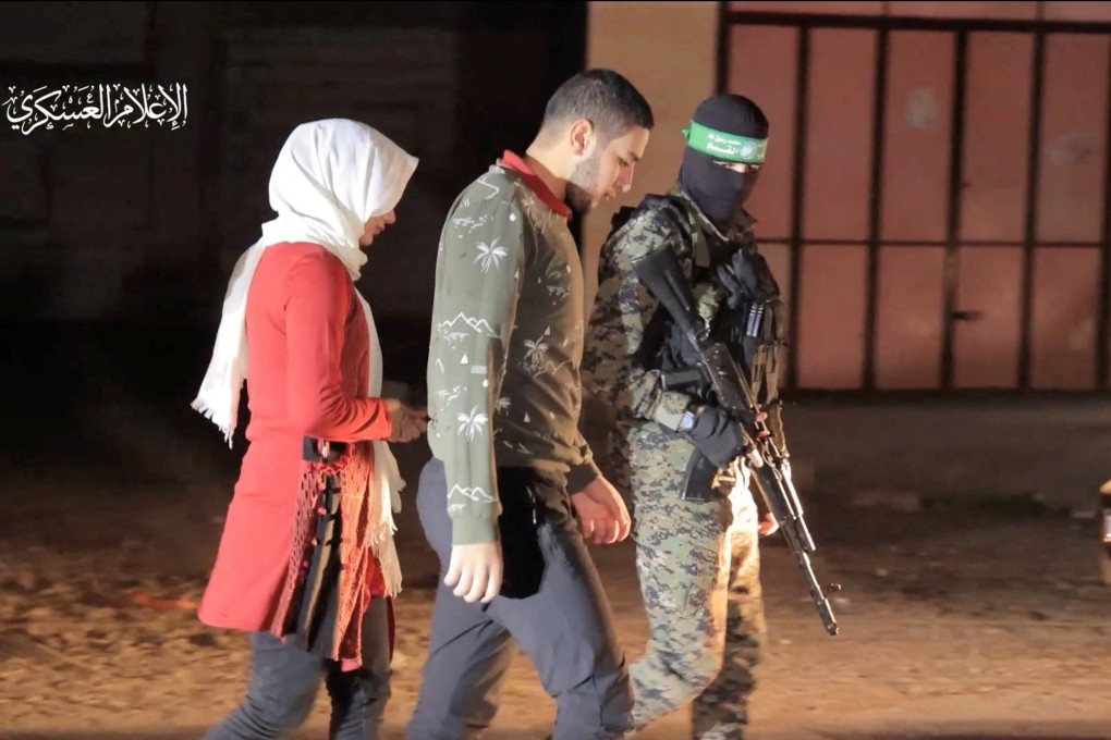 Hostages who were abducted by Hamas gunmen during the October 7 attack on Israel are handed over by militants to the International Red Cross in an unknown location in the Gaza Strip on November 30, 2023. We look at how the meaning of the word “hostage” has changed over time. Photo: Reuters