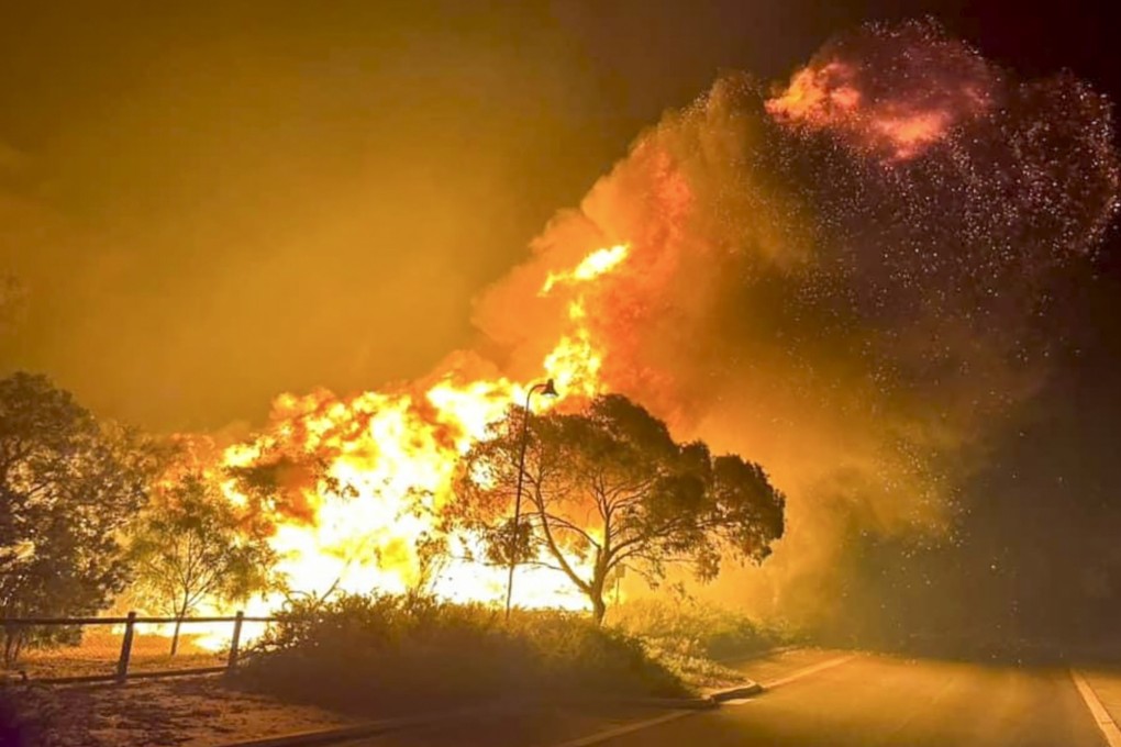 A fire rages in bushland near the Wannaroo, north of Perth, on November 23. Photo: DFES via AP
