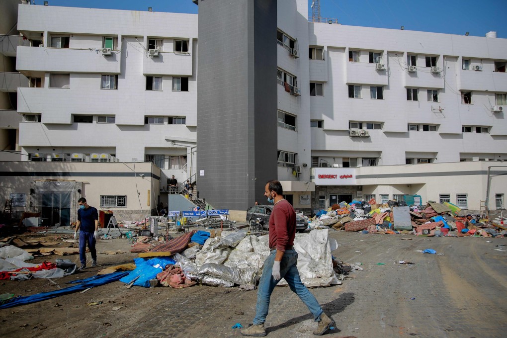 A Palestinian man walks near al-Shifa hospital in Gaza City on November 26. Photo: AFP