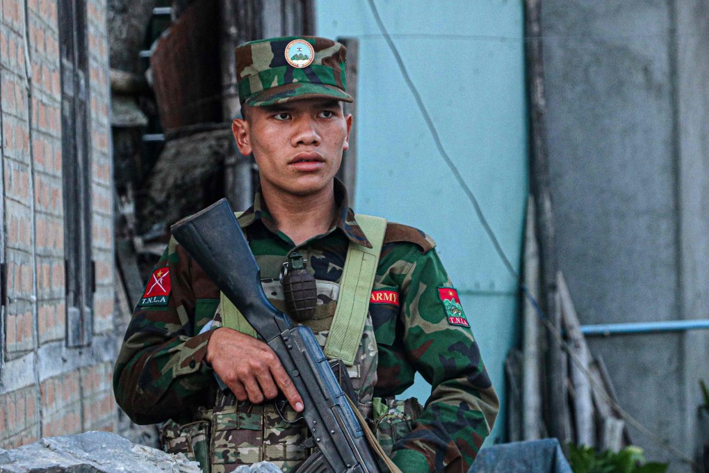 A fighter of the ethnic rebel group Ta’ang National Liberation Army (TNLA) stands guard in the town of Namhkam in northern Shan state. Photo: AFP