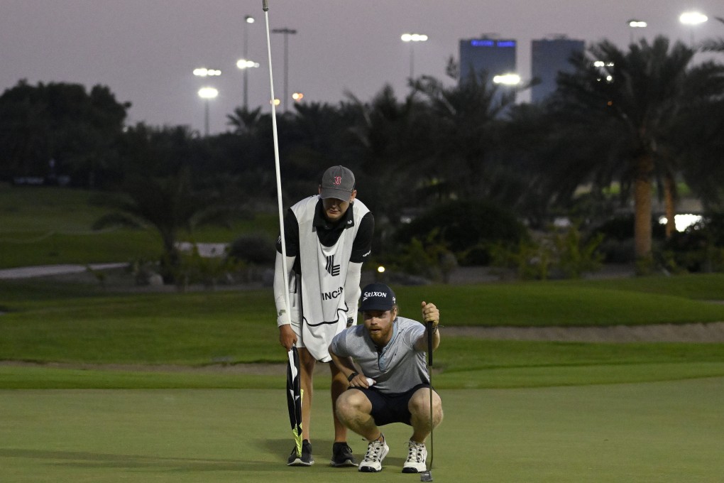 Kieran Vincent and caddie Jacob Flech line up a putt during the LIV Golf Promotions event at Abu Dhabi Golf Club. Asian Tour