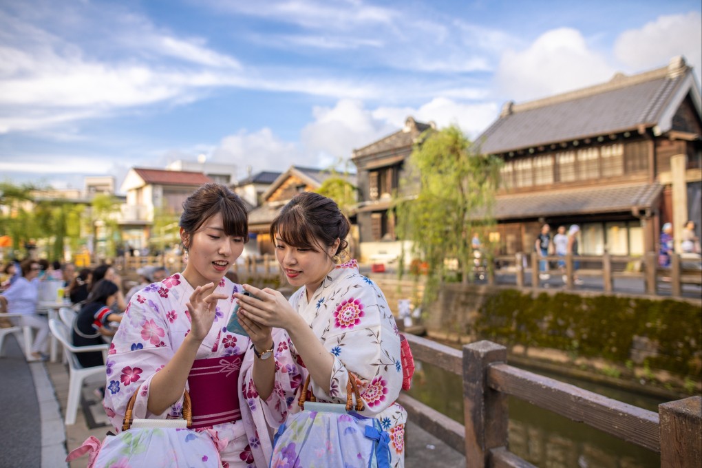 Young tourists in Japan using a smartphone. Social media plays a big role in how Gen Zers and millennials travel. We look at trends among young tourists, from taking inspiration from Instagram to why authentic experiences are key. Photo: Getty Images