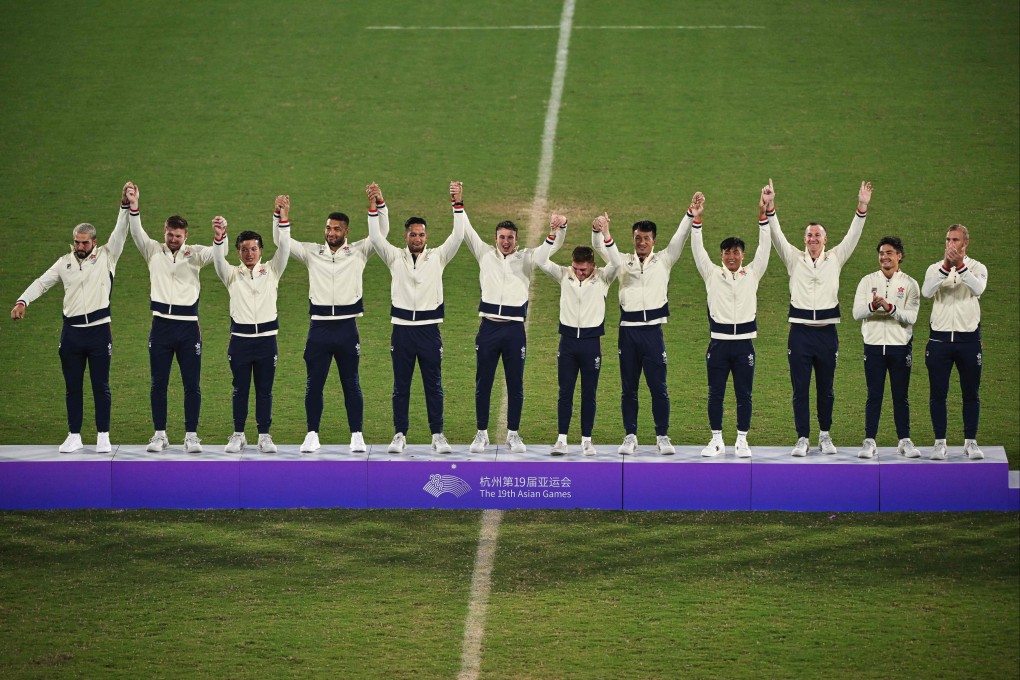 Hong Kong’s men’s rugby sevens players step on to the podium in Hangzhou after winning a second successive Asian Games gold. Photo: AFP