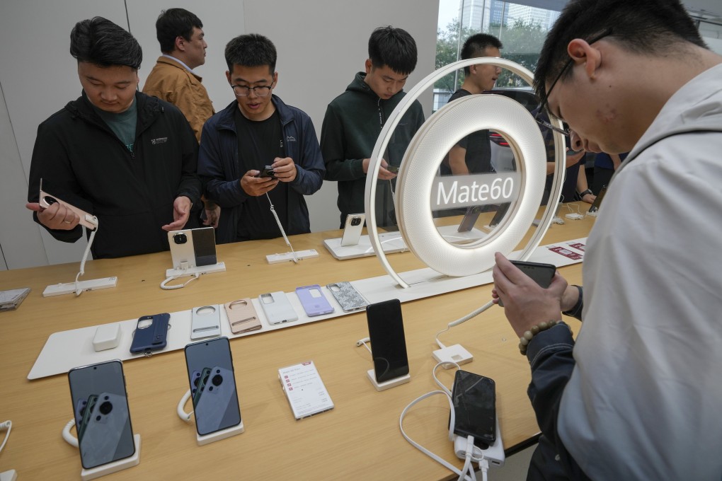 Customers try out the Mate X5, Huawei’s latest foldable device and Mate 60 series, during a product launch in Beijing, September, 25, 2023. Photo: AP