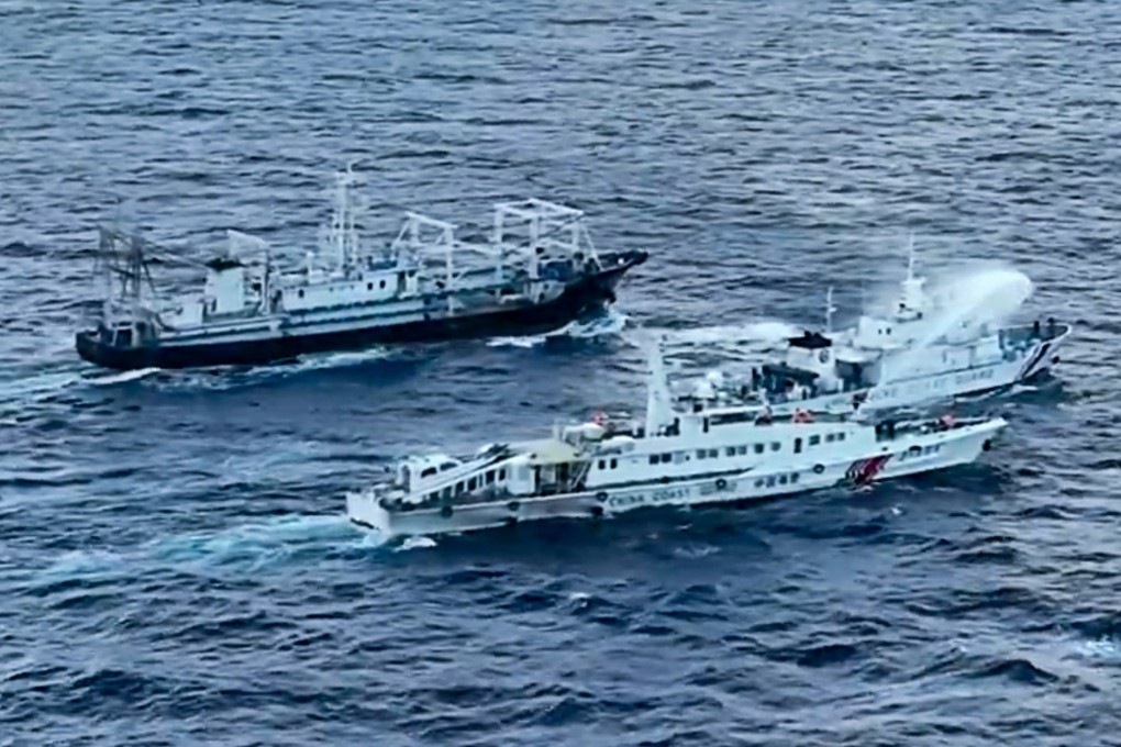 An image from video provided by the Philippine Coast Guard shows a Chinese Coast Guard ship, bottom, using a water cannon on a Philippine ship, BRP Cabra, centre, as it approaches Second Thomas Shoal on Sunday. Photo: Philippine Coast Guard