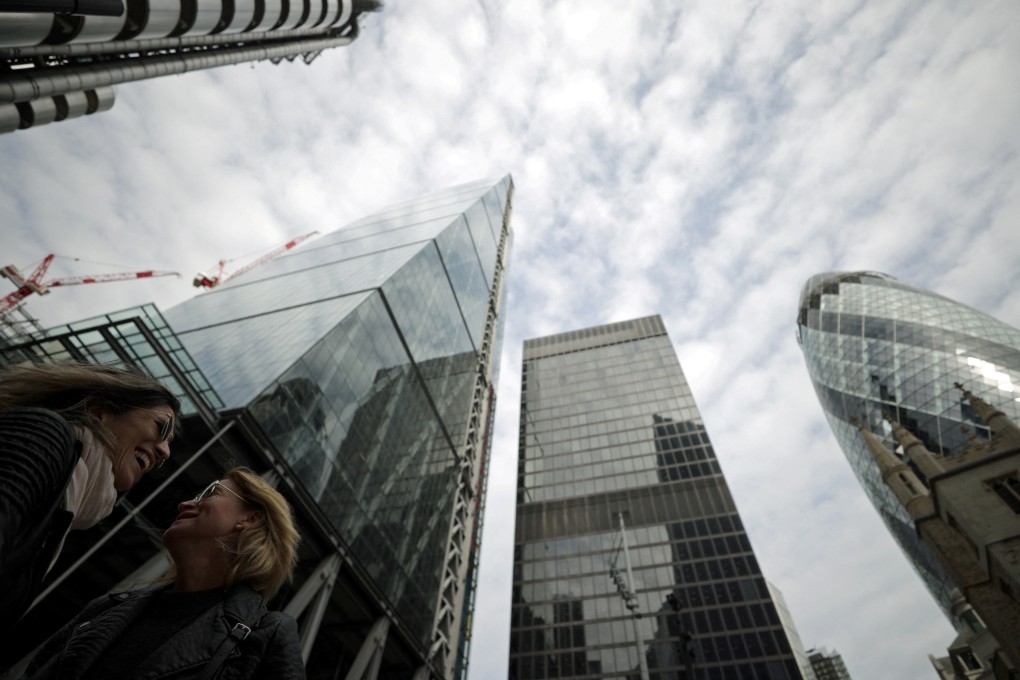 People walk through the City of London financial district in London, Britain. Photo: Reuters