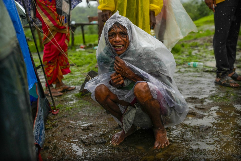 A woman whose family members are trapped under rubble wails after a landslide washed away houses in Raigad district, western Maharashtra state, India, in July. Photo: AP