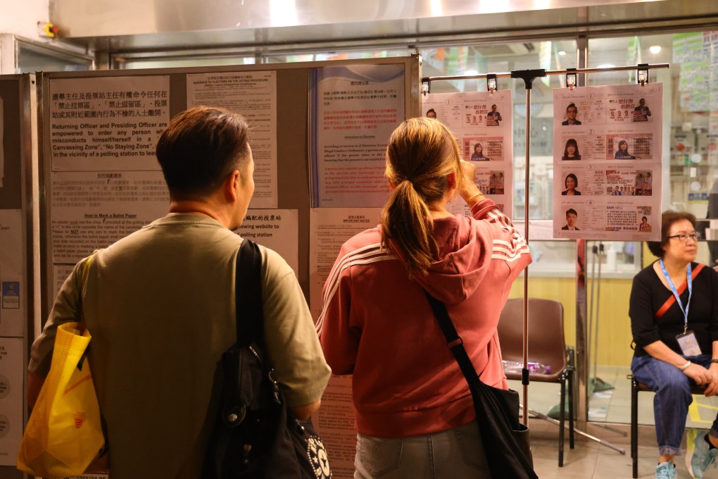 Voters check candidate information outside a  polling station for the district council election in Wong Tai Sin on December 10. Photo: Dickson Lee