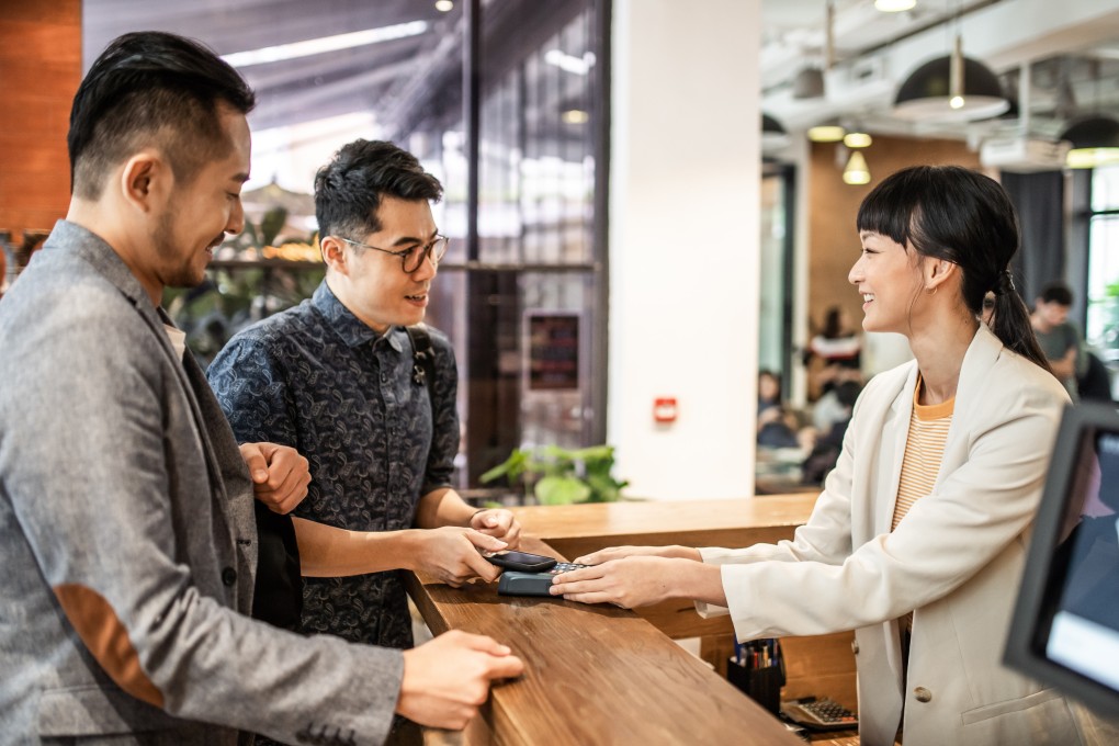 Hotel guests pay as they check out of a hotel. Some chains are allowing guests to check in and out whenever it suits them in the wake of the Covid-19 pandemic, while others have pushed back check-in from 3pm to 4pm. Photo: Getty Images