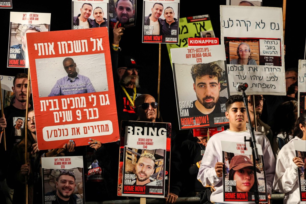 Protesters in Tel Aviv, Israel, hold signs showing portraits of hostages during a demonstration last Saturday calling for their release. Photo: AFP