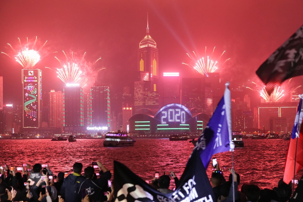People watch a Symphony of Lights show at Tsim Sha Tsui during Hong Kong’s 2019 New Year’s celebrations. Photo: Winson Wong