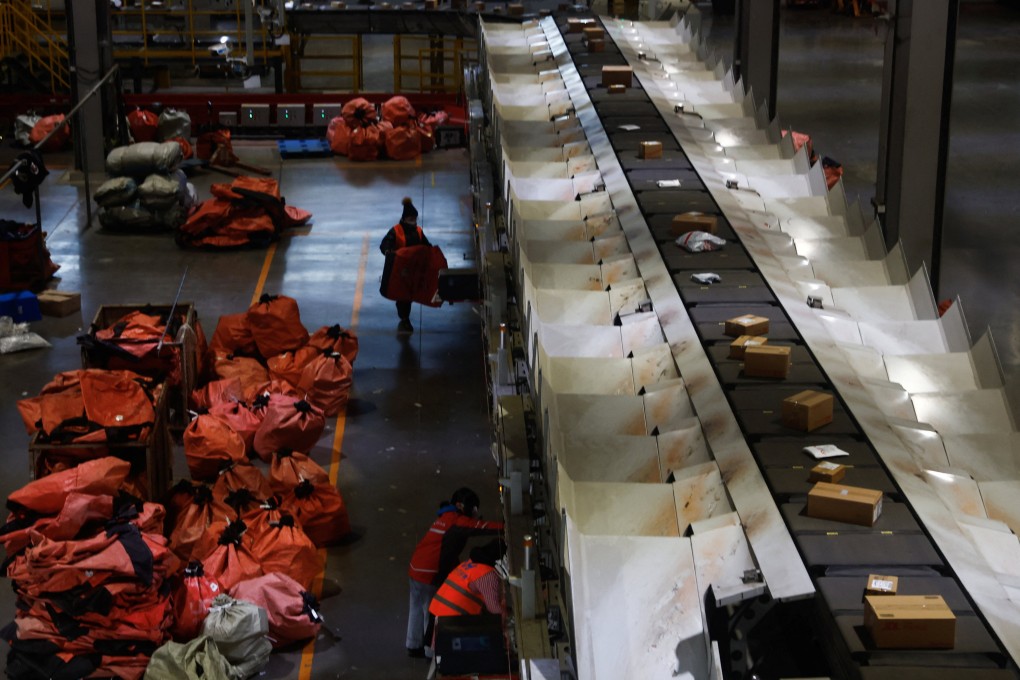 Employees check packages at JD Logistics in Beijing. Photo: Reuters