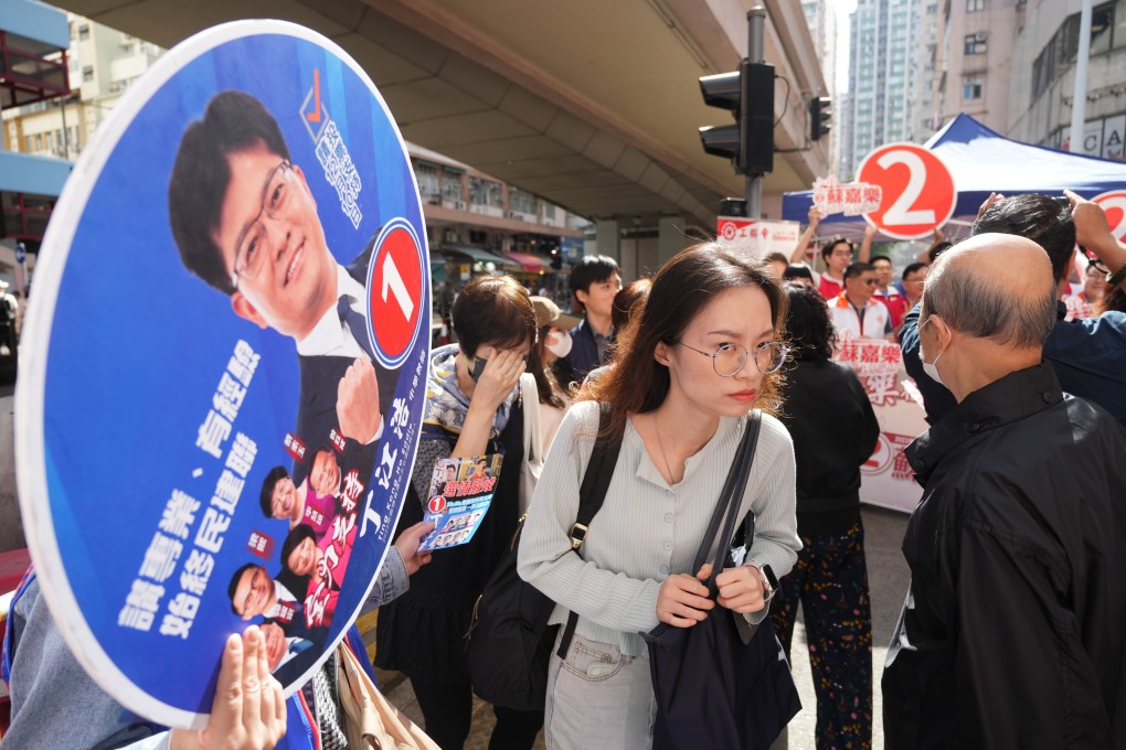 Political parties canvass voters for the district council election at North Point on December 10. Photo: Sam Tsang