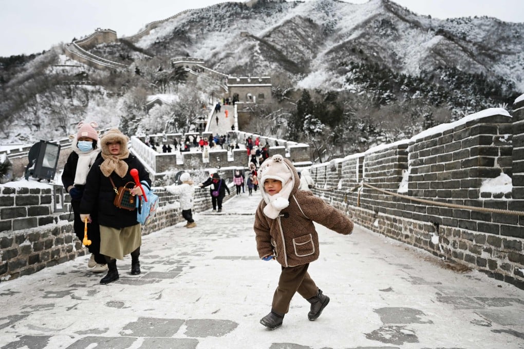 A child plays on the Great Wall of China north of Beijing on Friday. Schools and some train services in the Chinese capital were shut down following a cold spell that brought snow to northern China. Photo: AFP