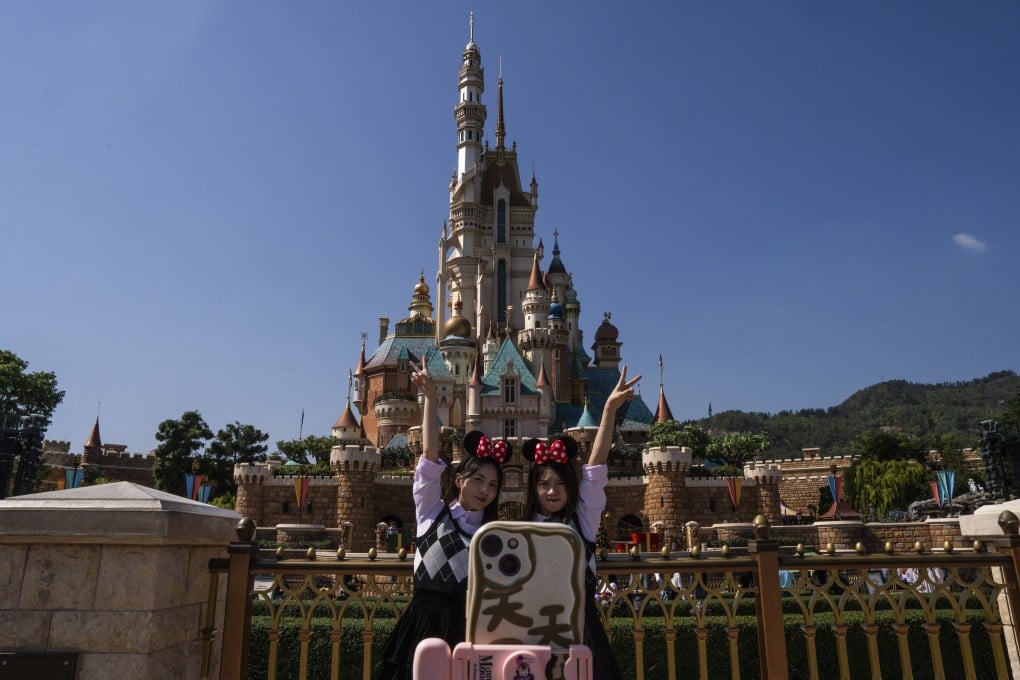 Visitors pose for photographs in front of the Castle of Magical Dreams at Hong Kong Disneyland on November 20. Hong Kong Disneyland is the smallest Disney resort campus in the world. Photo: AP