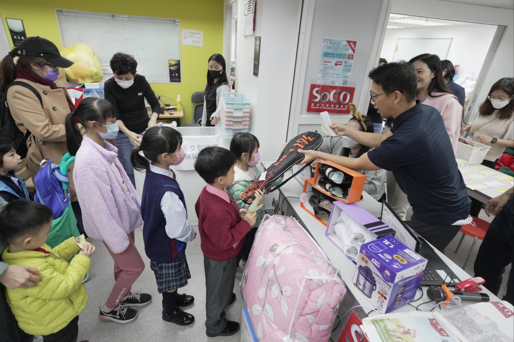 Children queue up for Christmas presents from SoCO’s “Santas” at the NGO’s annual festive giveaway. Photo: Elson Li