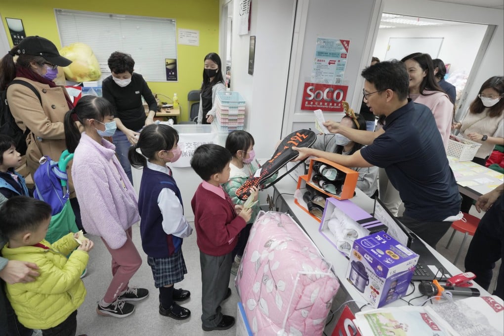 Children queue up for Christmas presents from SoCO’s “Santas” at the NGO’s annual festive giveaway. Photo: Elson Li