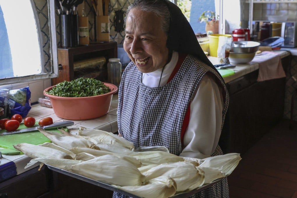 Maria Ines Maldonado carries a tray of corn husks stuffed with chicken and salsa verde at the Convent of the Mothers Perpetual Adorers of the Blessed Sacrament in Mexico City. Convent-made delicacies are helping monks and nuns win fans and pay the bills over Christmas. Photo: AP