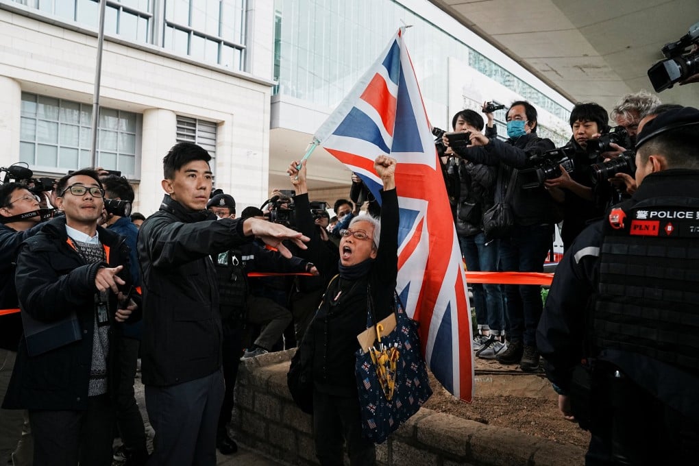 Protester Alexandra Wong waves a Union Jack flag outside the West Kowloon Magistrates’ Courts on Monday during the national security trial of Jimmy Lai. Photo: Reuters