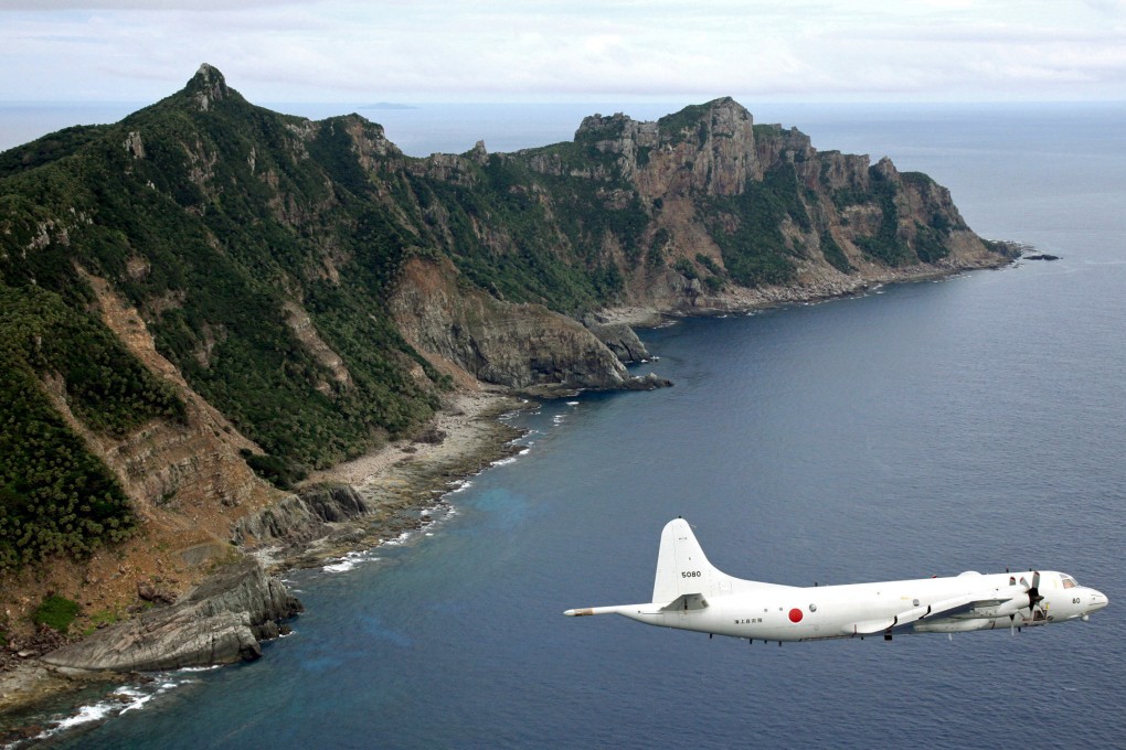 A Japanese surveillance plane flies over the disputed Diaoyu Islands in the East China Sea. File photo: Kyodo News via AP