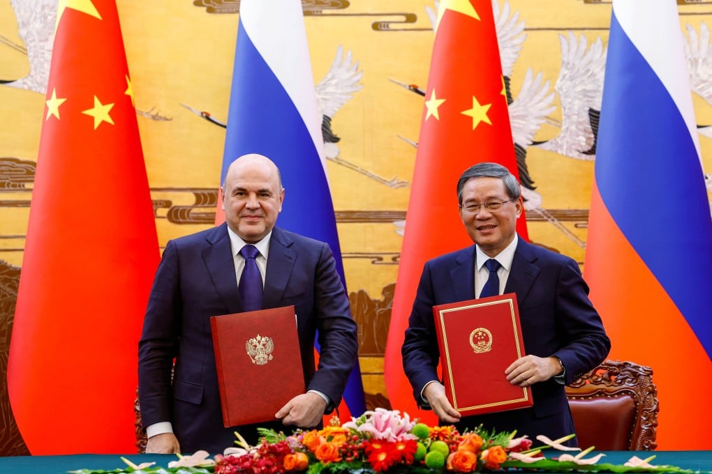 Russian Prime Minister Mikhail Mishustin (left) and Chinese Premier Li Qiang attend a signing ceremony during a meeting in Beijing on Tuesday. Photo: EPA-EFE