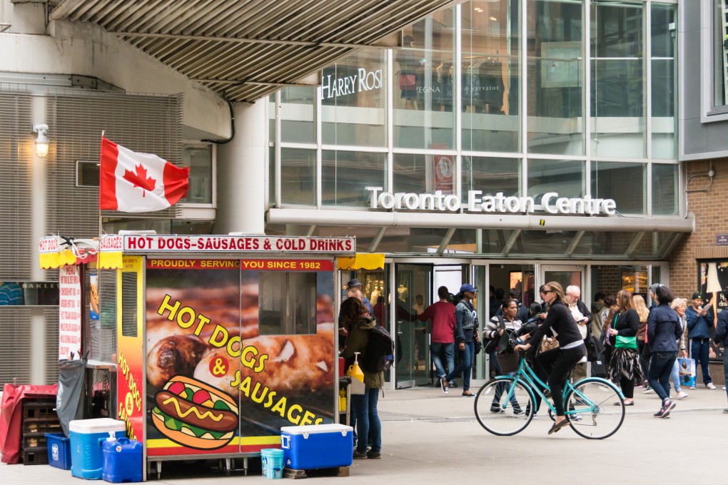 Hot dog stand with Canadian flag at entrance of Eaton Centre. Photo: Getty Images