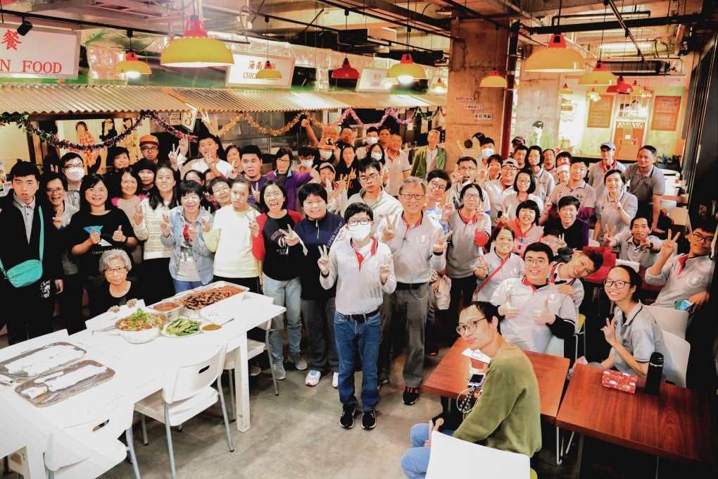 Koh Seng Choon (standing front centre, wearing grey trousers), Dignity Kitchen’s founder, with his staff at a Christmas party at the social enterprise’s Hong Kong outlet in Mong Kok, which employs and trains differently abled and disadvantaged people.