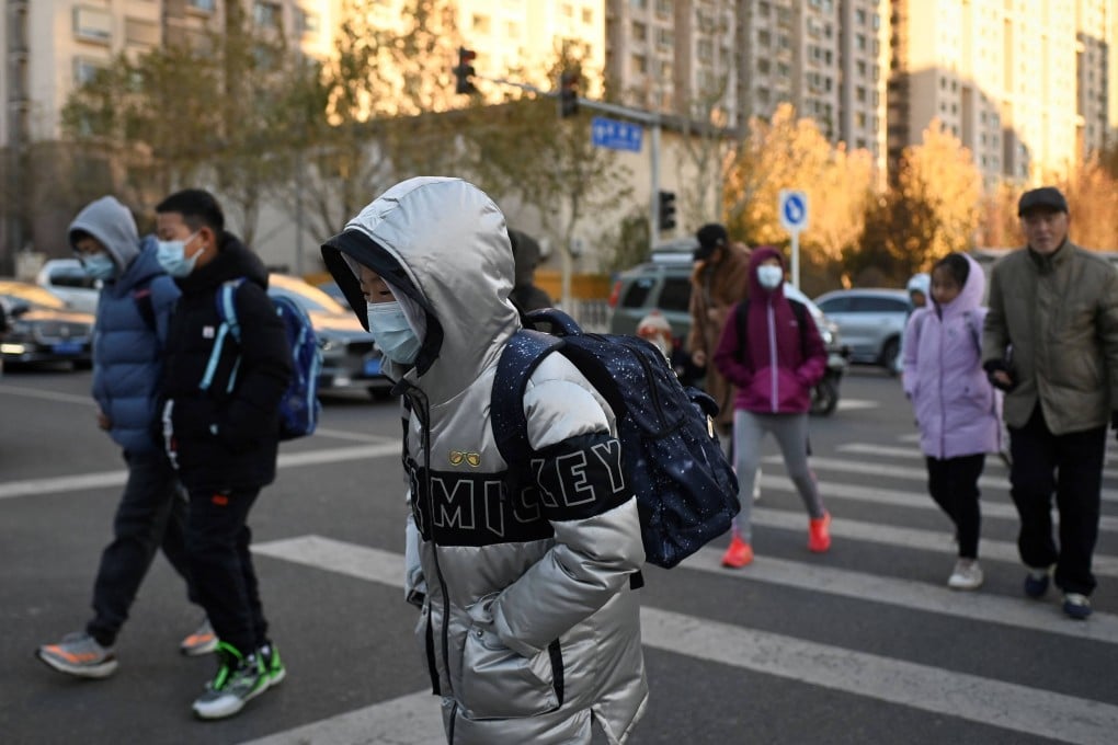 Students head for classes on a cold day in Beijing on November 29. After nine years of compulsory schooling, children in China must pass an exam to enter an academic high school. Photo: AFP