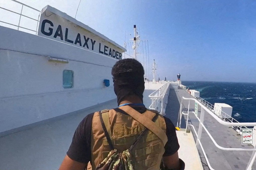 A Houthi fighter stands on the Galaxy Leader cargo ship in the Red Sea. Photo: Houthi Military Media / Handout via Reuters