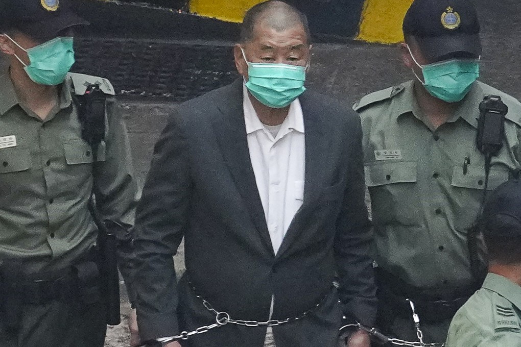 Media mogul Jimmy Lai Chee-ying, founder of Apple Daily, walks to a prison van to head to court in 2020. Photo: Winson Wong