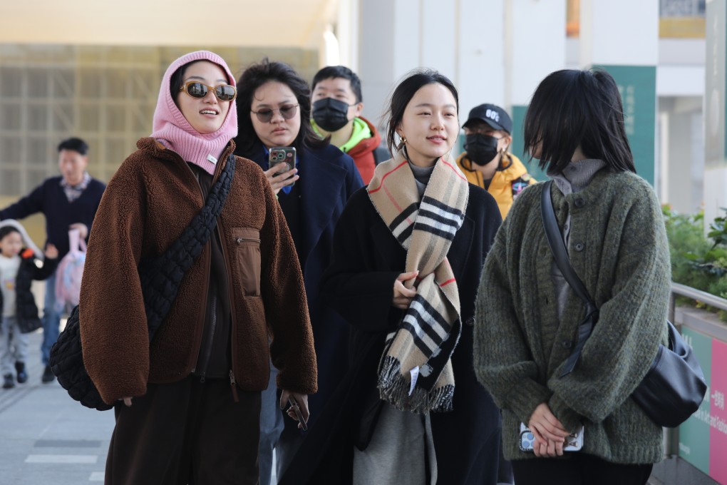 People dressed for the cold at West Kowloon Cultural District. Experts say the city will experience fewer cooler days in coming winters as global warming pushes the mercury higher. Photo: Xiaomei Chen