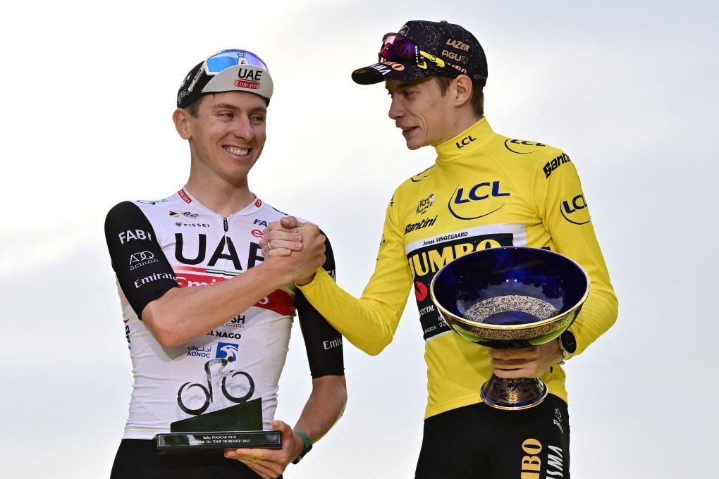 Jumbo-Visma’s Danish rider Jonas Vingegaard (right) with overall leader’s yellow jersey shakes hands with UAE Team Emirates’ Slovenian rider Tadej Pogacar after winning the 21st and final stage of the 110th edition of the Tour de France. Photo: AFP