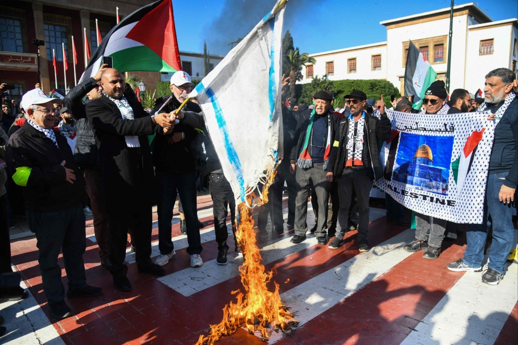 Moroccans burn an Israeli flag during a protest in Rabat on Sunday, in solidarity with Gaza. Photo: AFP