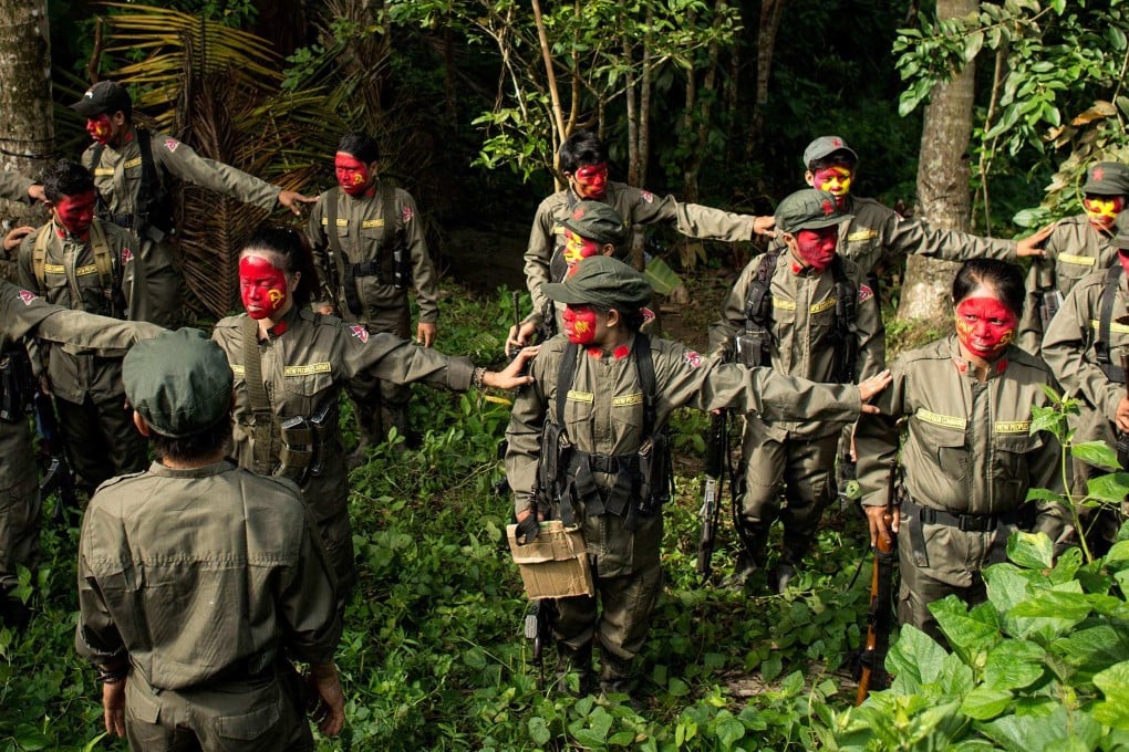 Communist rebels of the New People’s Army stand in formation in the Sierra Madre mountain range. Philippine troops killed nine communist rebels in a series of firefights on December 25. Photo: AFP