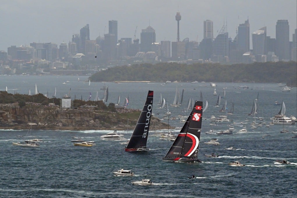 SHK Scallywag (right) and Andoo Comanche (left) lead around South Head during the Sydney Hobart Yacht Race. Photo: EPA-EFE