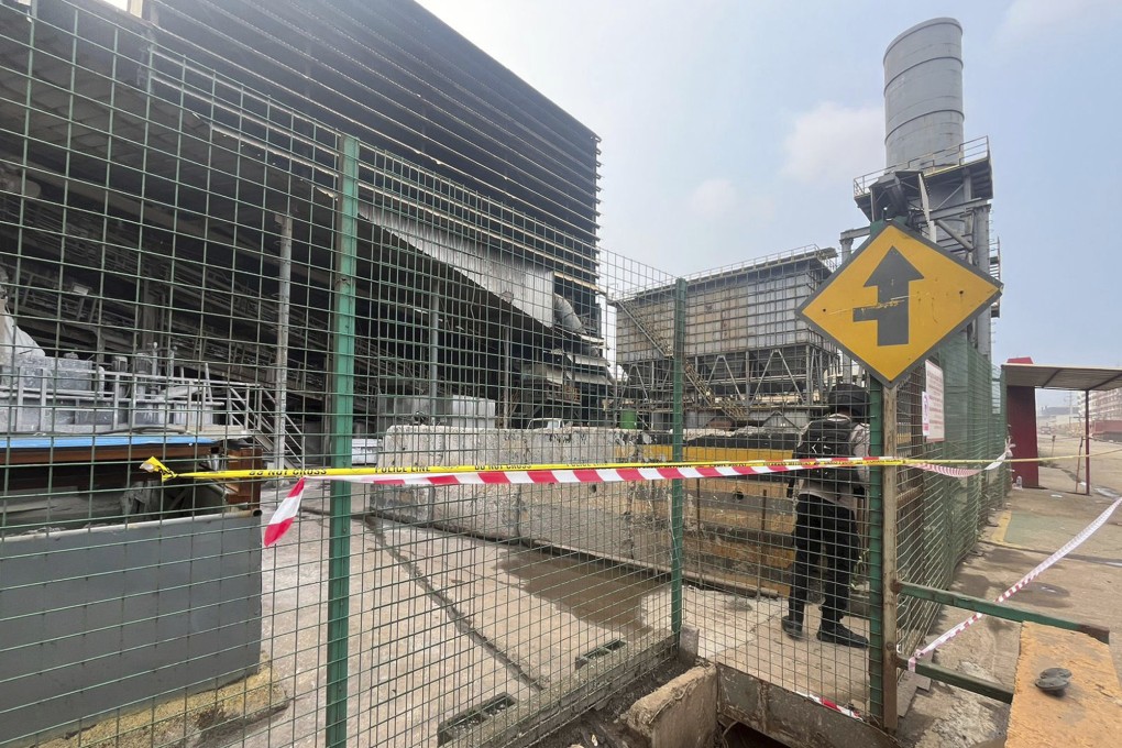 A police officer stands guard near the site where a furnace explosion occurred at nickel smelting plant in Morowali, Central Sulawesi, Indonesia on Sunday. Photo: AP