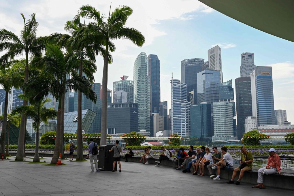 People rest next to ArtScience museum at the Marina Bay Sands in Singapore. Photo: AFP